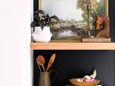 Shelves full of items against a black wall.