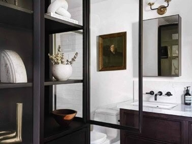 Cabinet with glass doors in a bath.