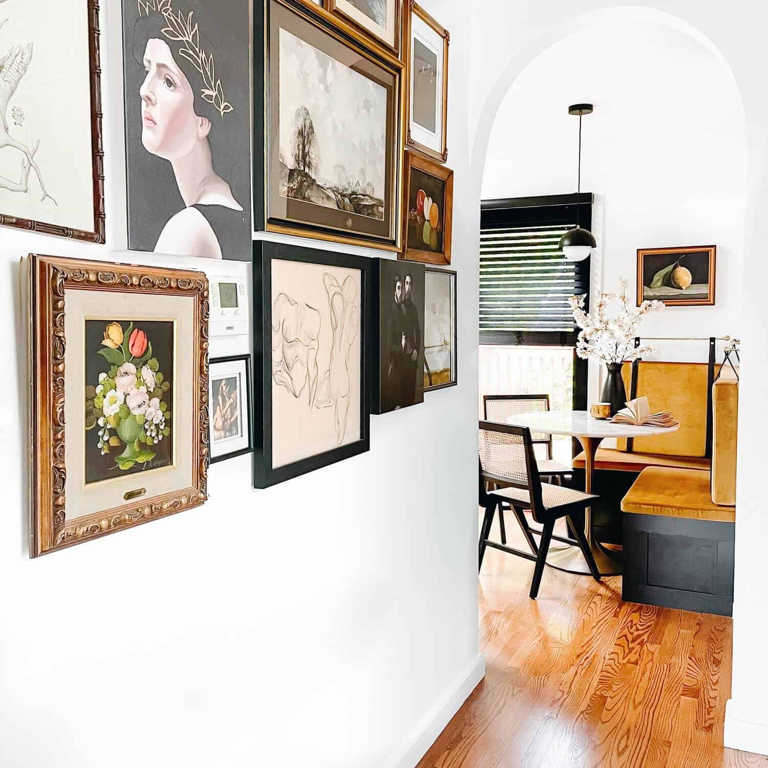 Gallery wall in a white hallway.