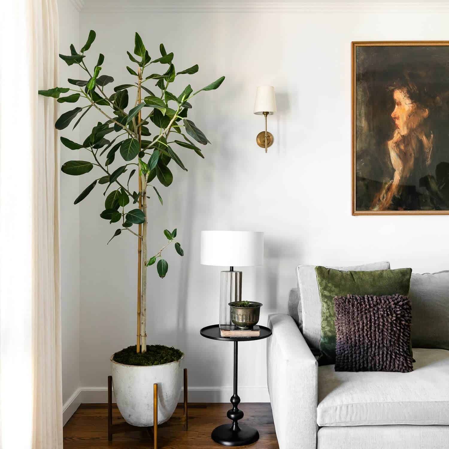 Black round side table next to a white sofa.