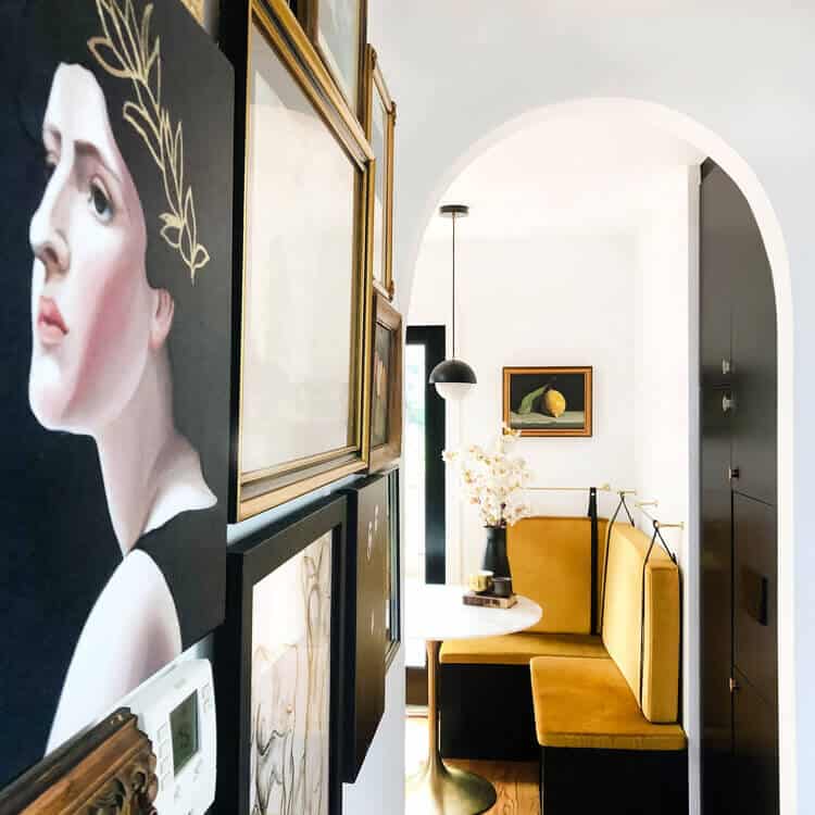 Gallery wall looking through an archway onto a brunch banquette.