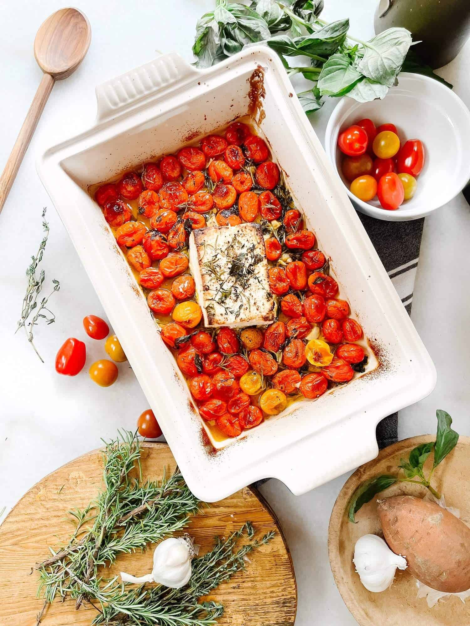 Baked feta and tomatoes in a dish.