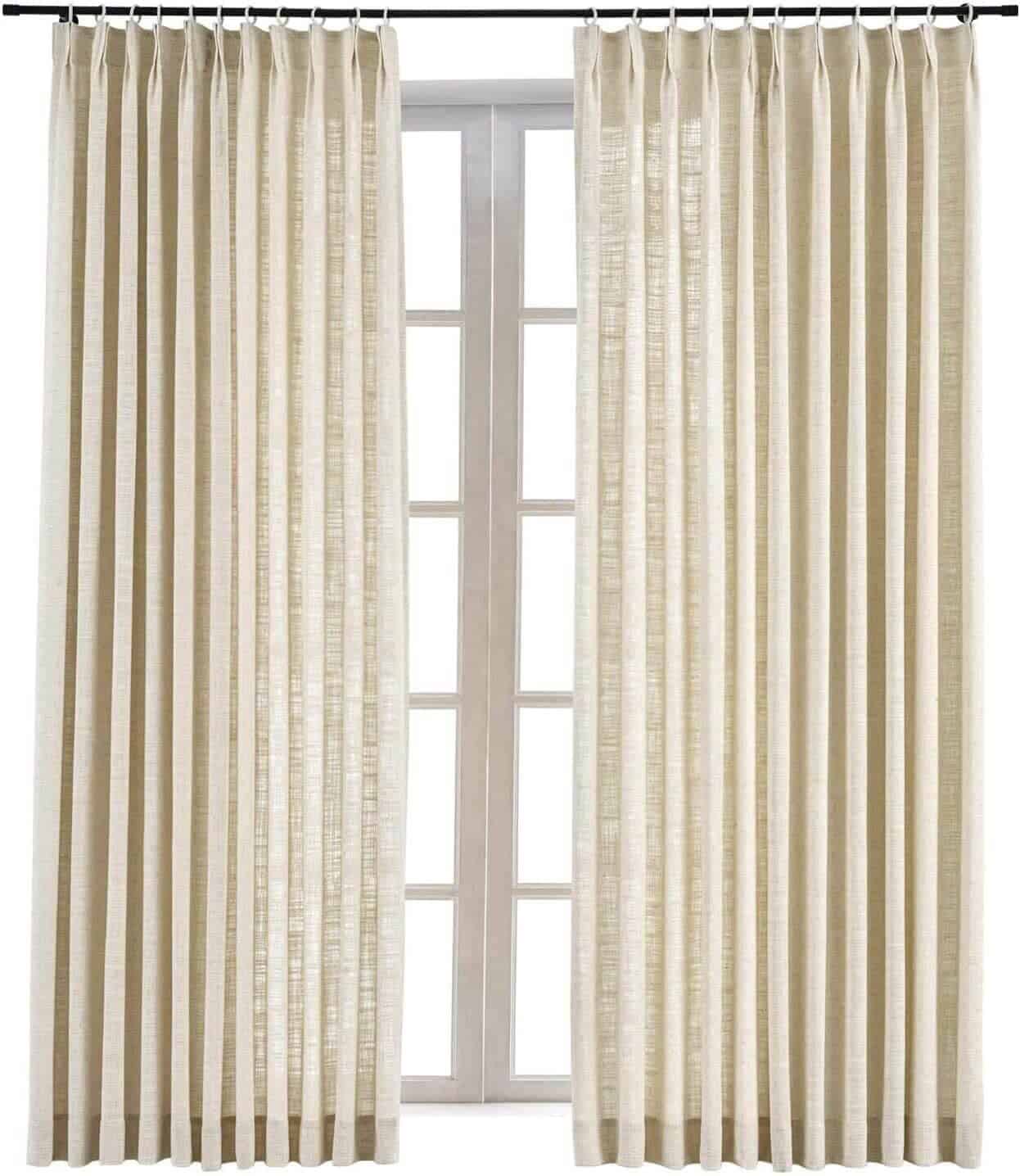 Pleated drapes in front of a bright window.