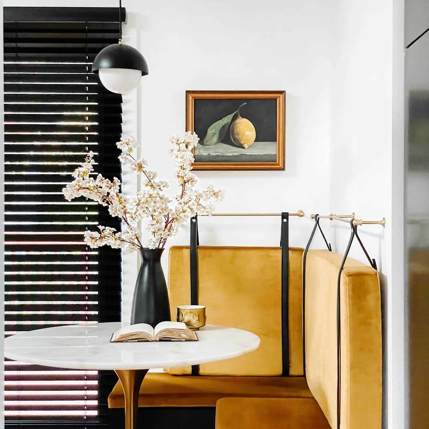 Gold banquette with a white table.