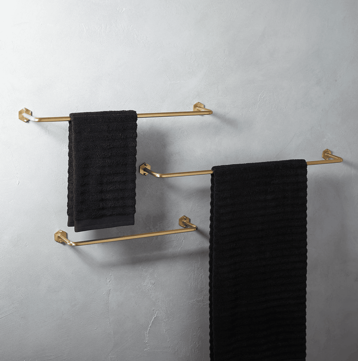 Set of three brass towel bars.
