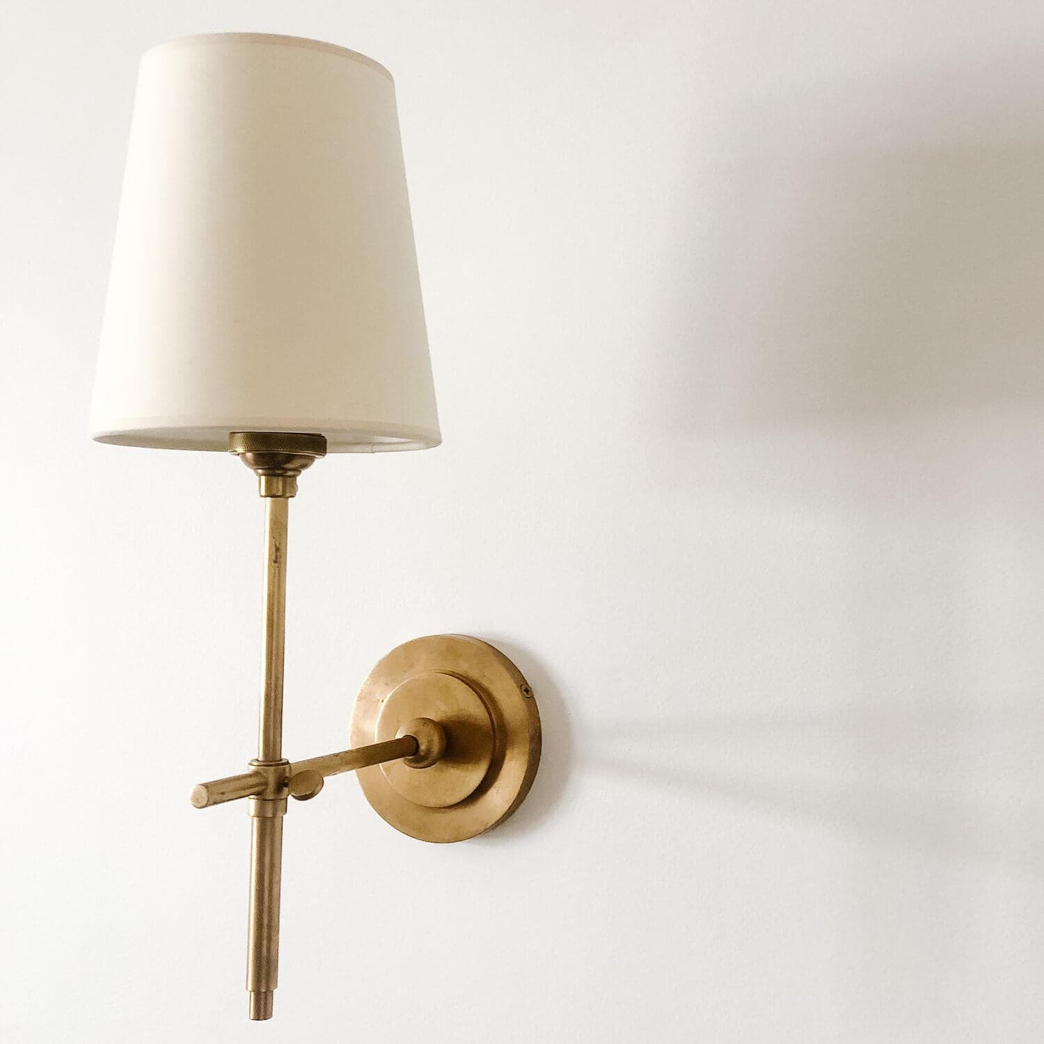 Bronze and cream wall sconce.