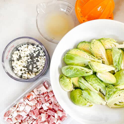 Chopped ingredients including pancetta, garlic, and brussels sprouts.