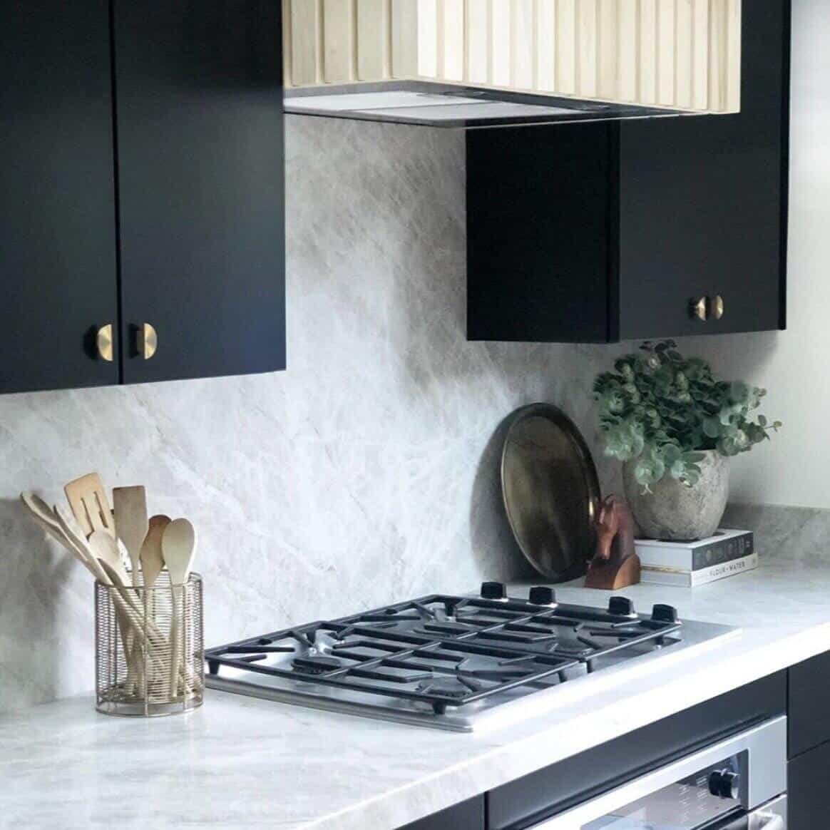 Gas range on marble countertops.