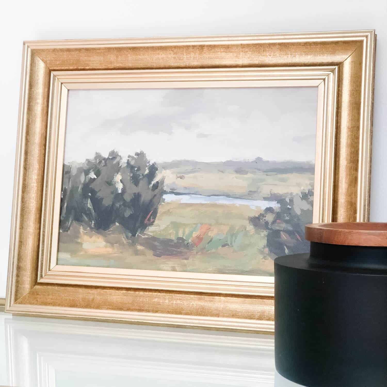 Landscape art in a golden frame.