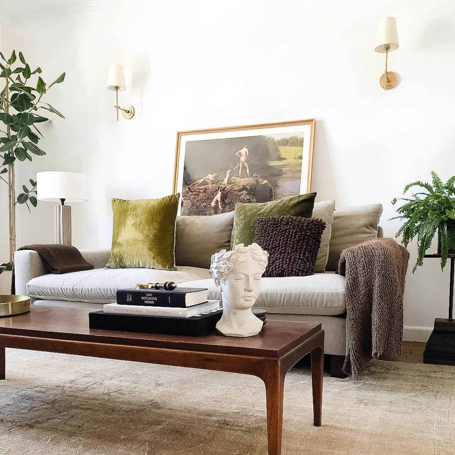 Bust on a coffee table in a room with a sofa.