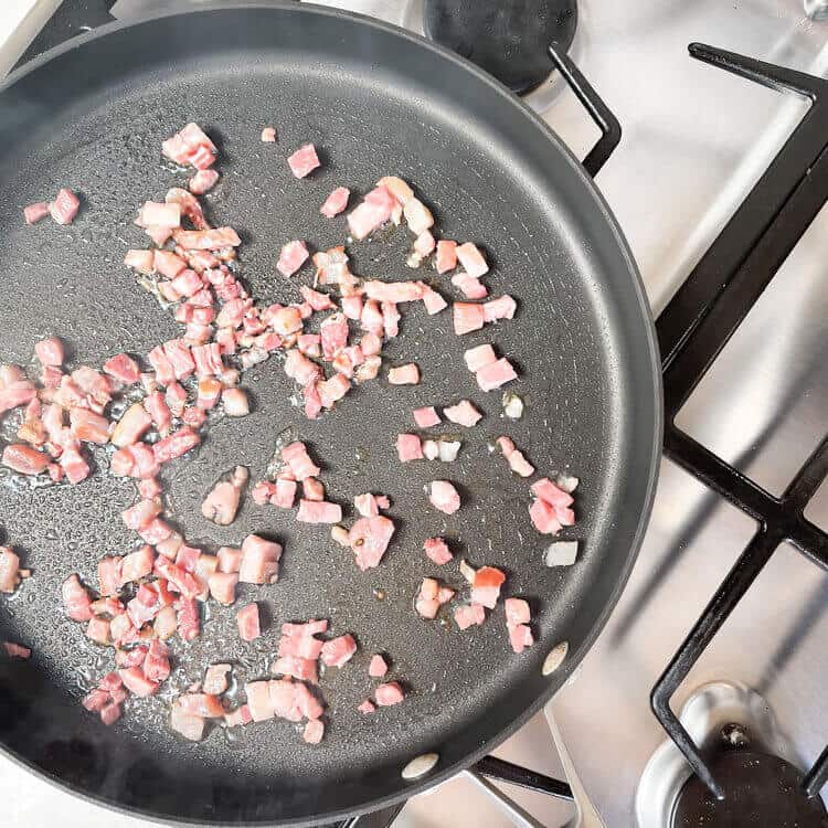 Chopped pancetta in a pan.