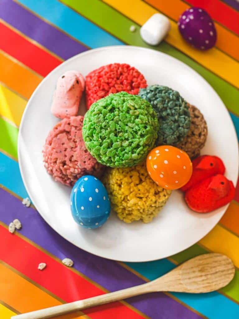 Plate of colorful Rice Krispie treats, Easter eggs, and Peeps.