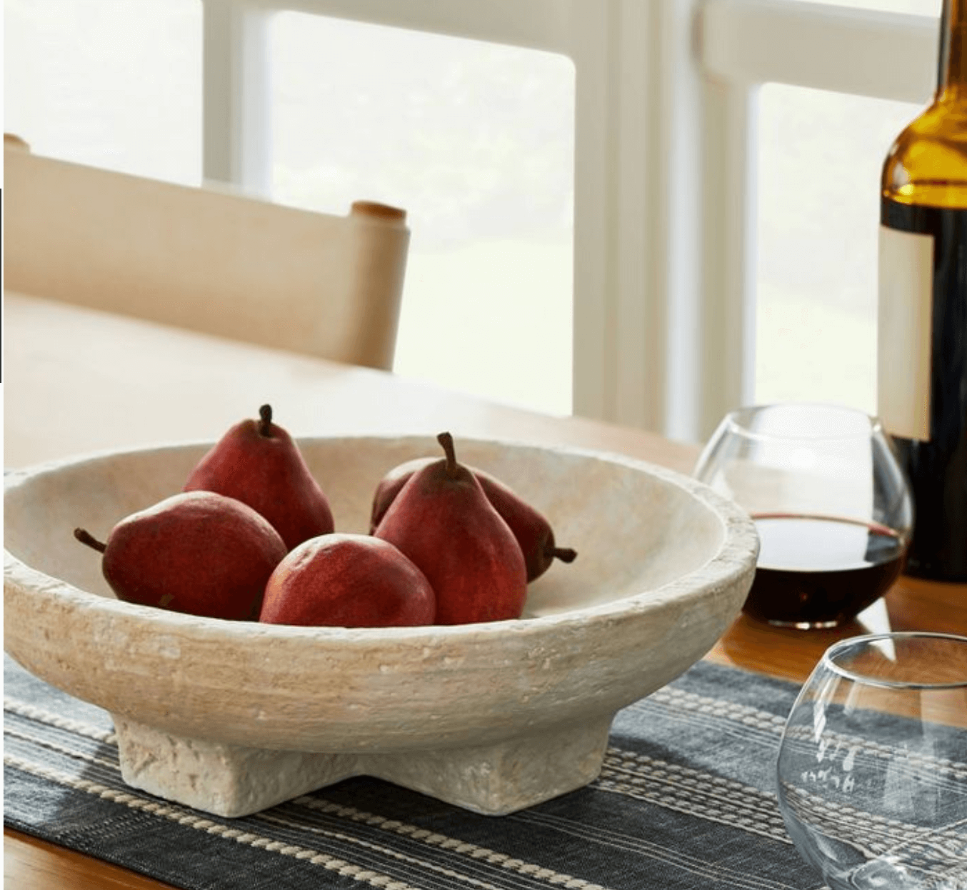 Pears in a footed terracotta bowl.