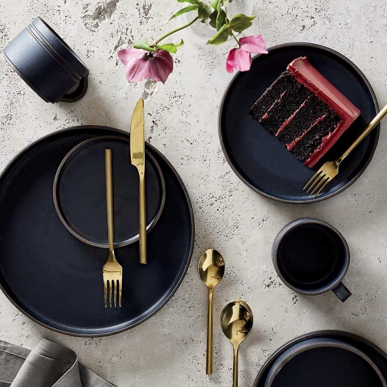 Brass silverware with black dishes.