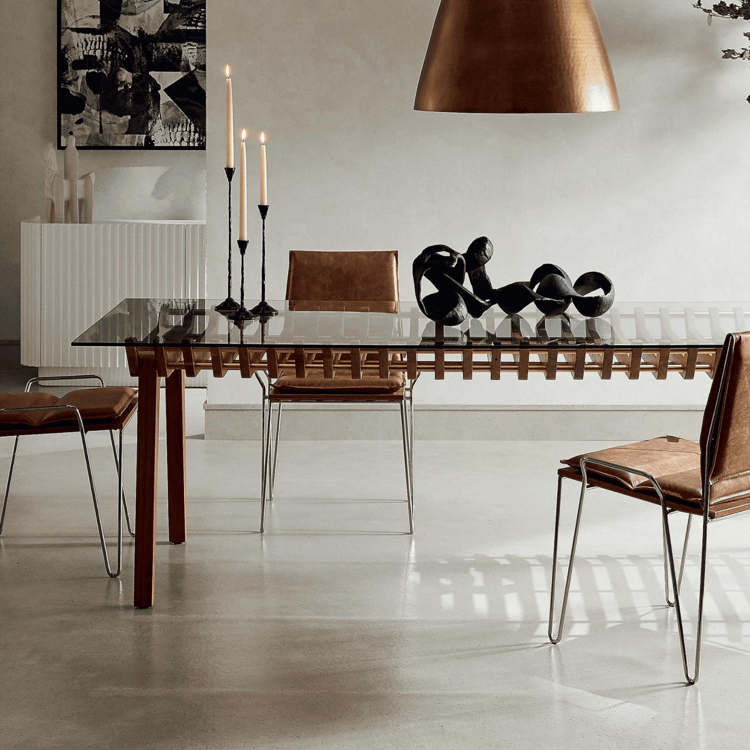 Rectangular glass table with brown chairs.