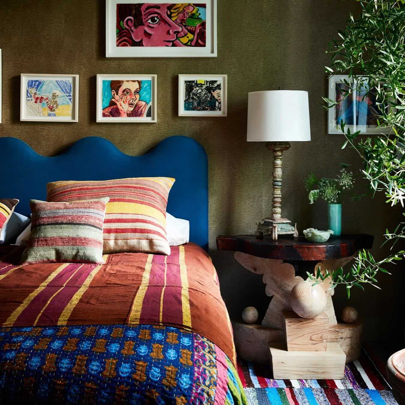 Blue headboard on a colorful bed.