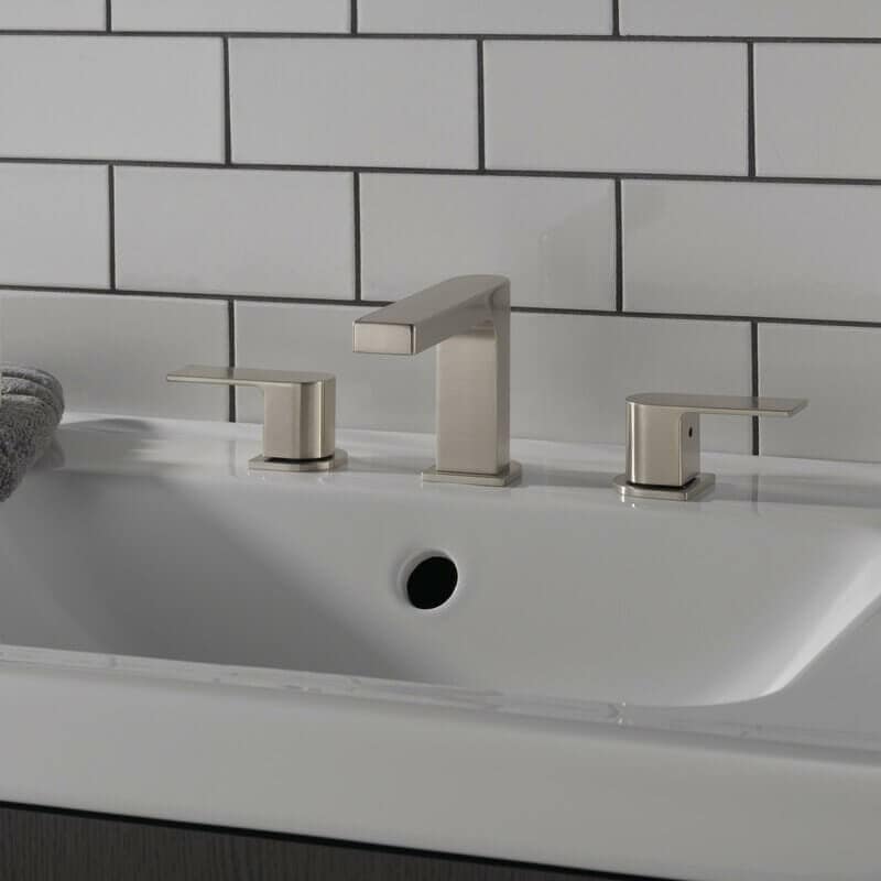 Silver faucet and handles in a white sink.