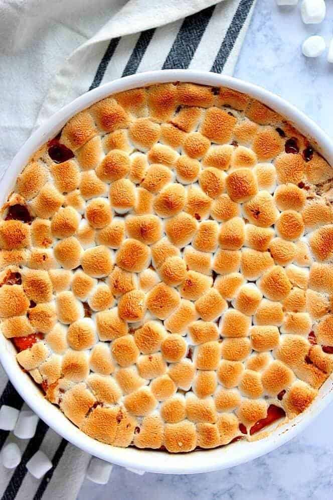 Sweet potato casserole topped with marshmallows.