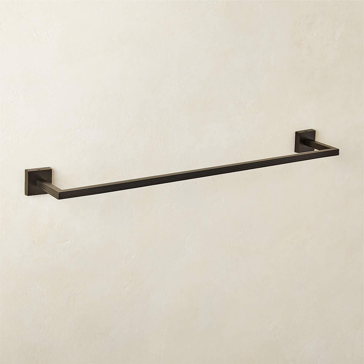 Matte black towel bar on a wall.
