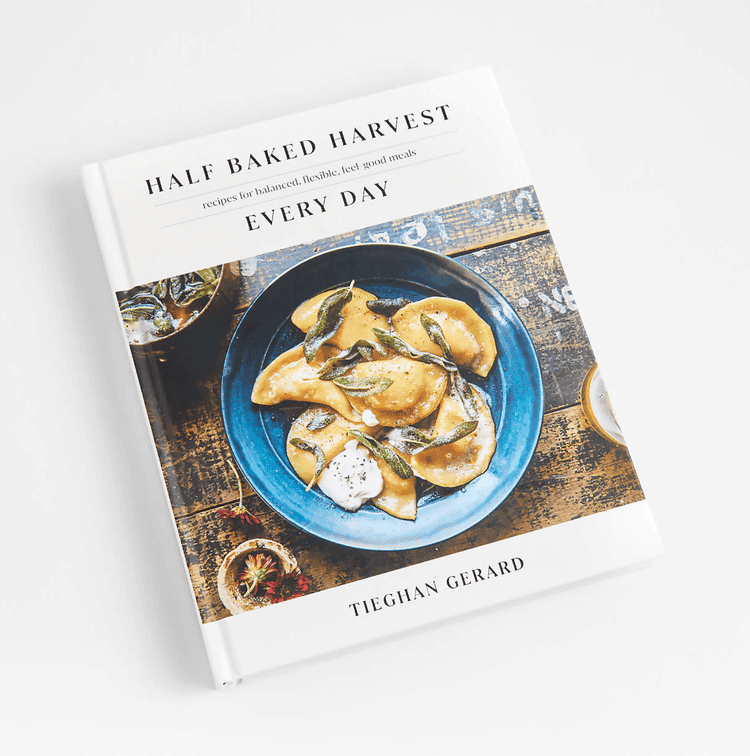 Picture of food on the cover of a book titles \"Half Baked Harvest\" by Tieghan Gerard.