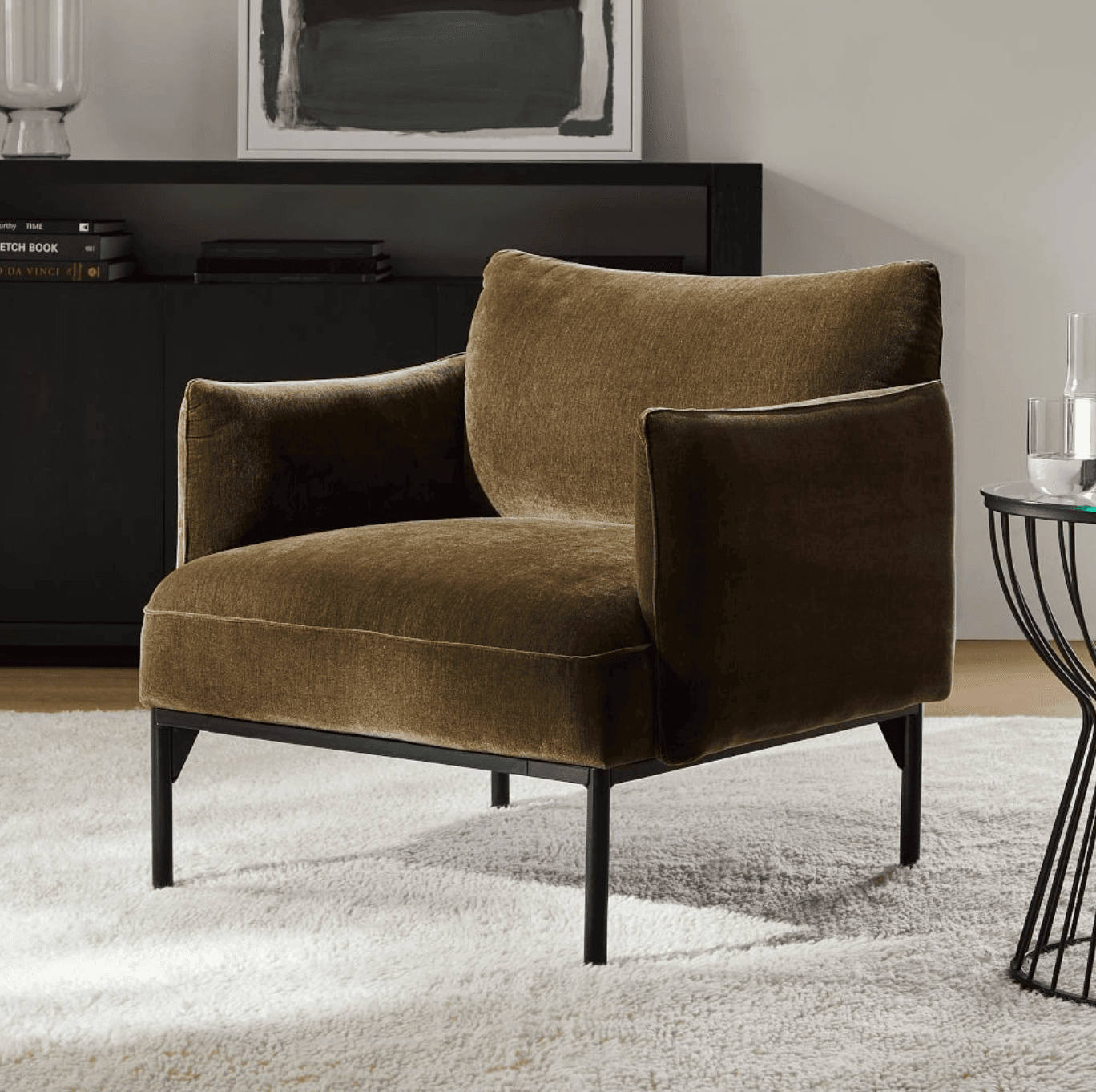 Armed, upholstered chair.