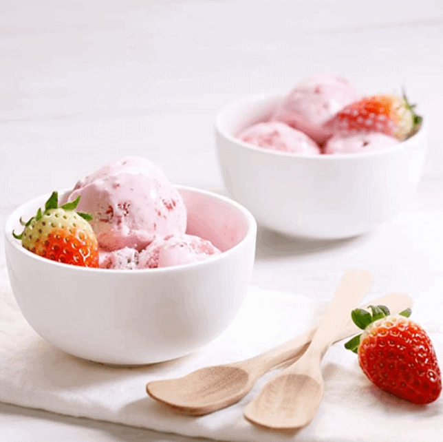 Two white bowls of ice cream.