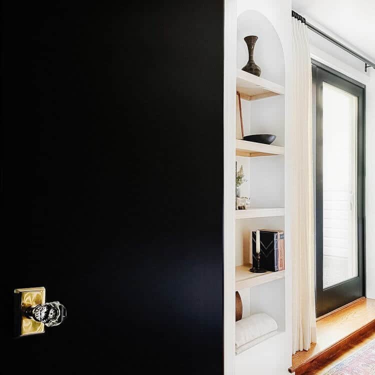 Crystal doorhandle on a black door.