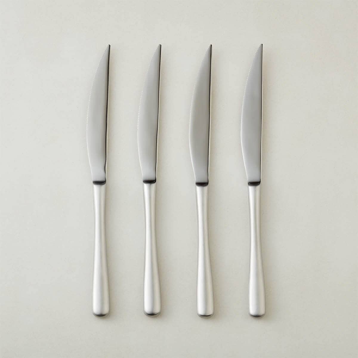 Four silver knives.