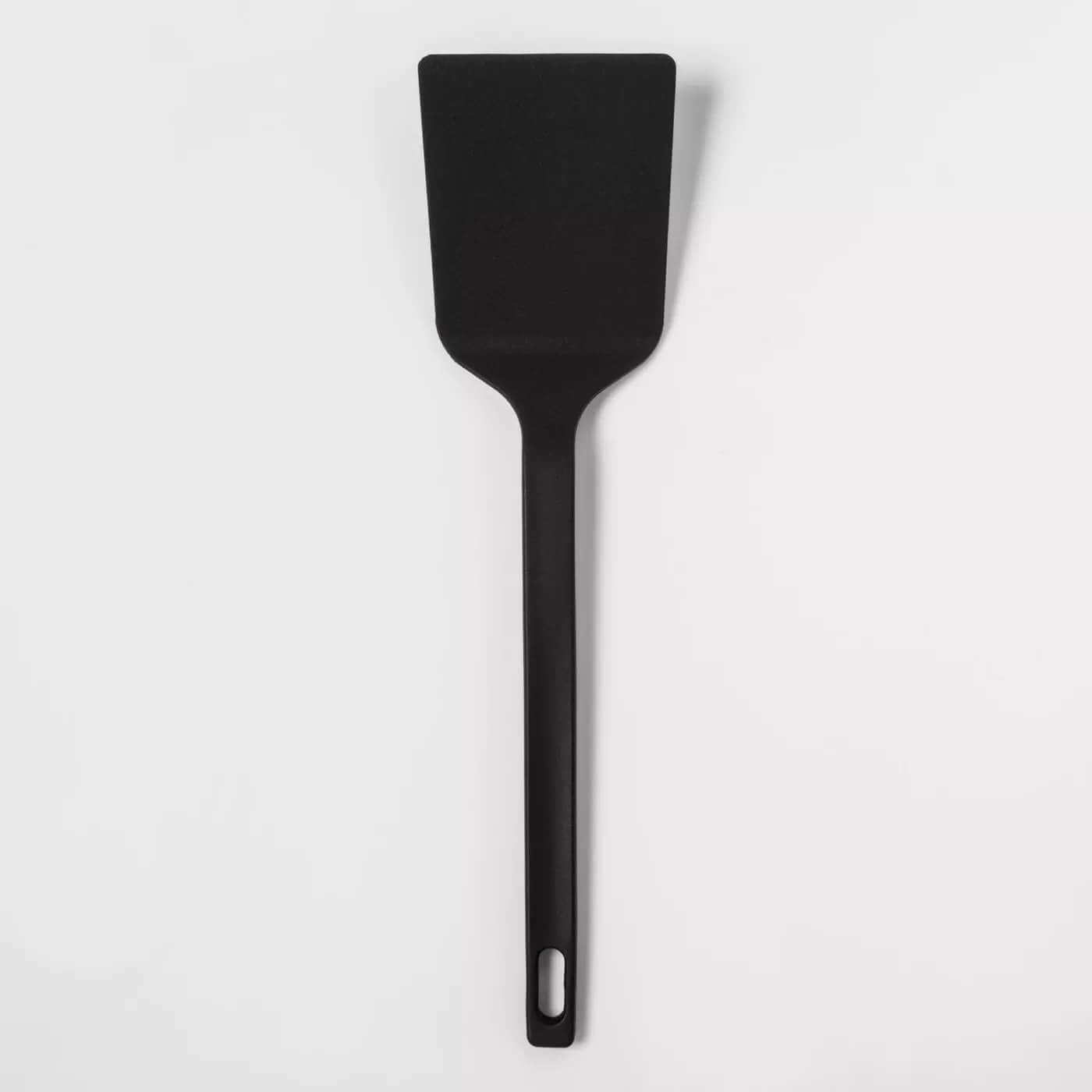 Black spatula on a white surface.