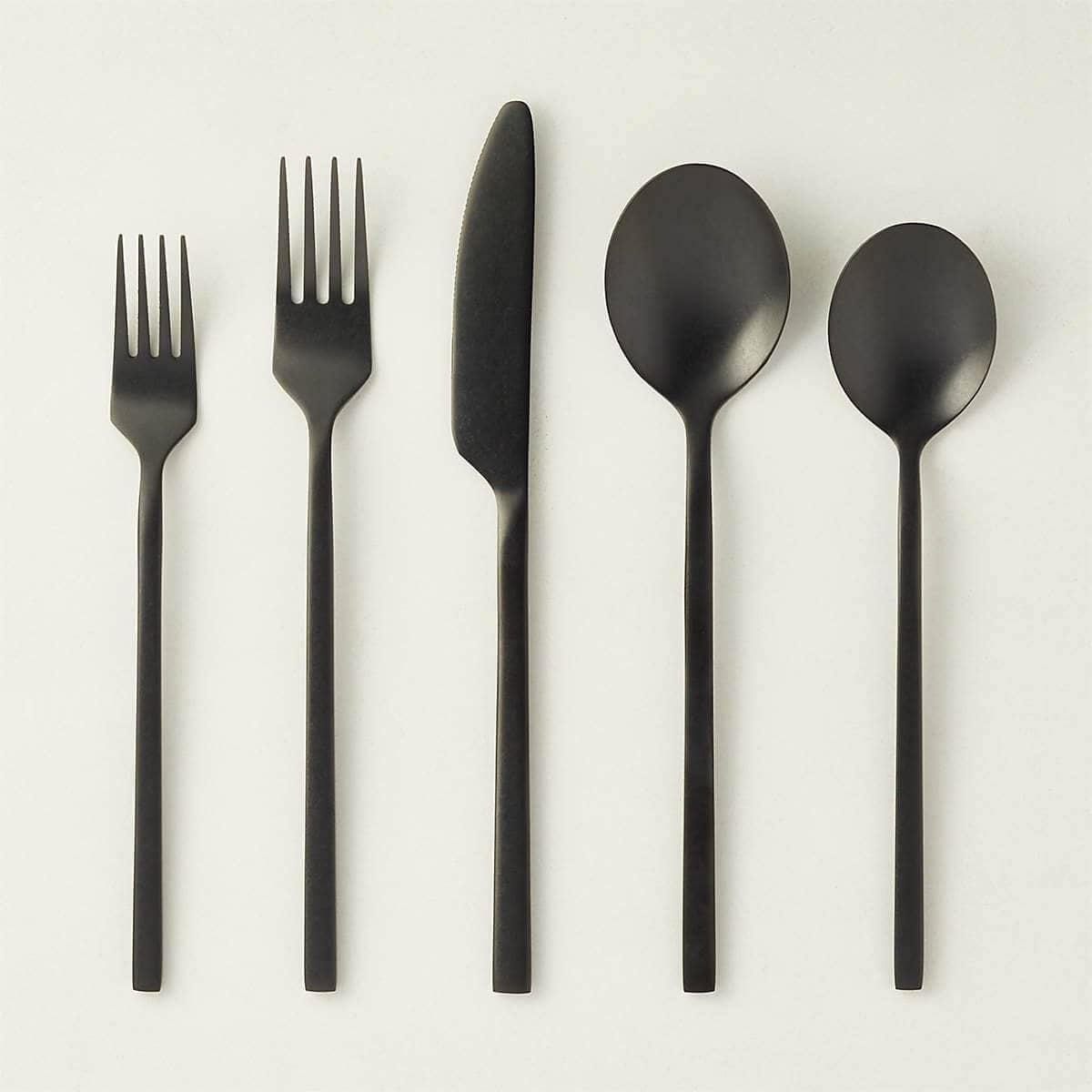 Set of five black pieces of silverware.