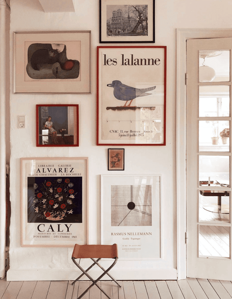 Framed posters in a gallery wall.