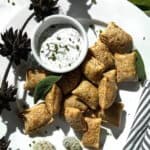 Air fryer pizza rolls on a plate with dip.