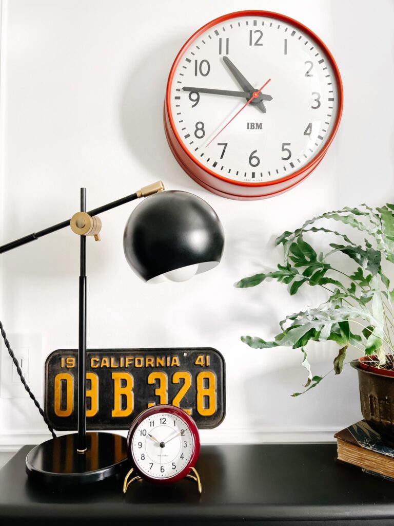 A clock hanging from the side of a table office desk decor ideas