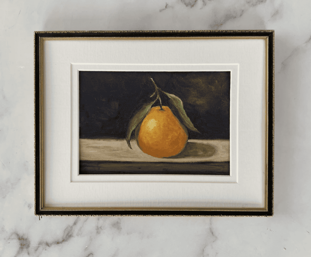 Framed picture of a clementine.