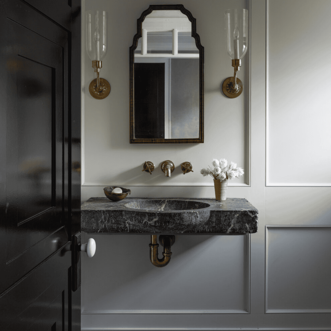 Dark sink and counter in a white room.