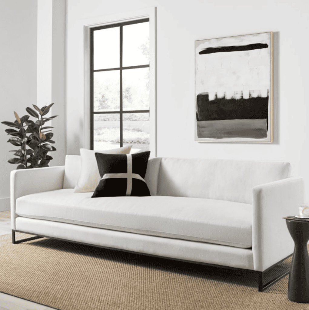 White sofa with black and white pillows.