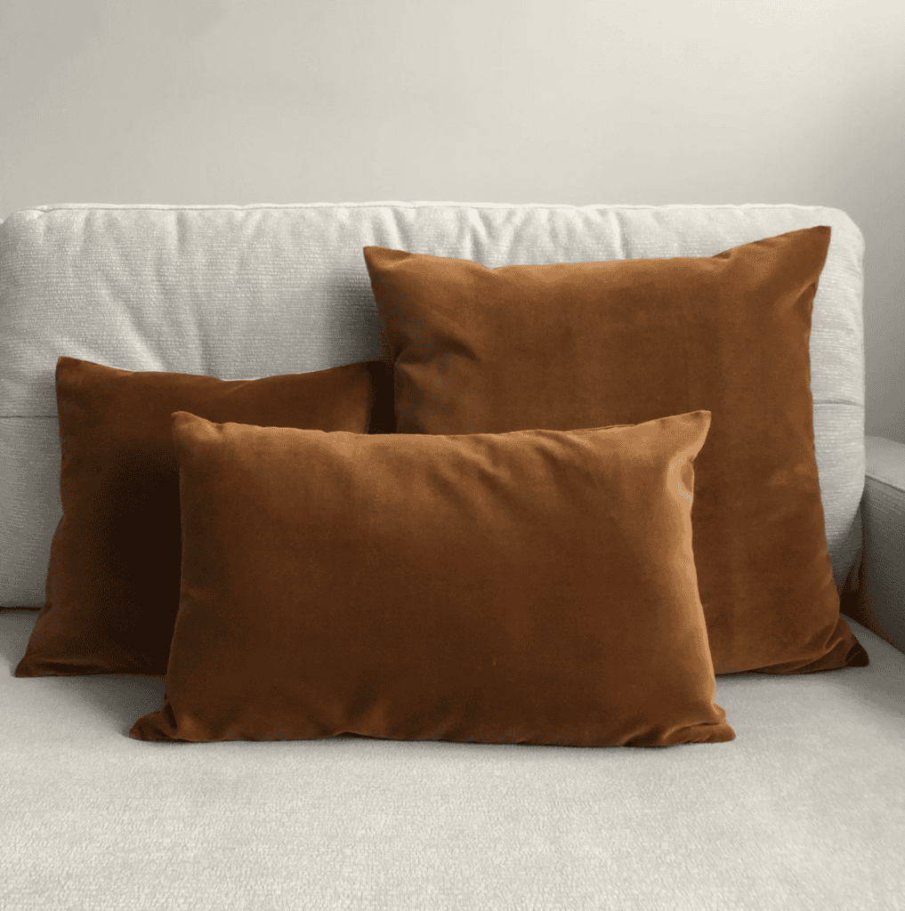 Three pillows on a sofa.