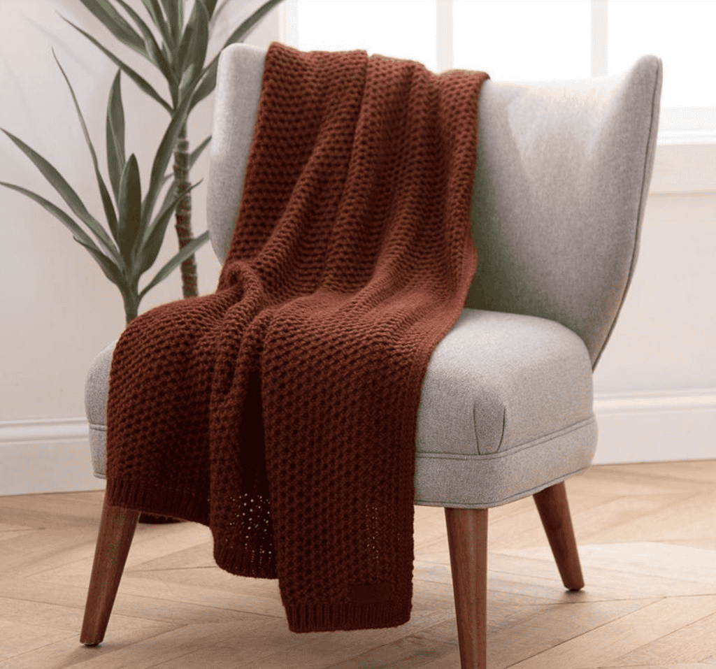 Throw blanket draped on a chair.