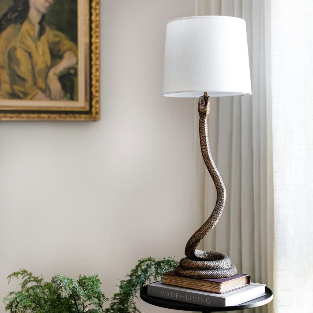 Snake lamp on a small table.