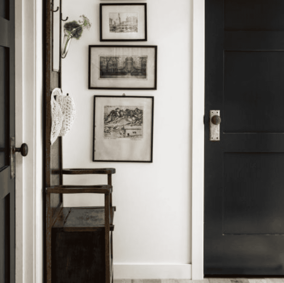 Art hanging next to a black door.