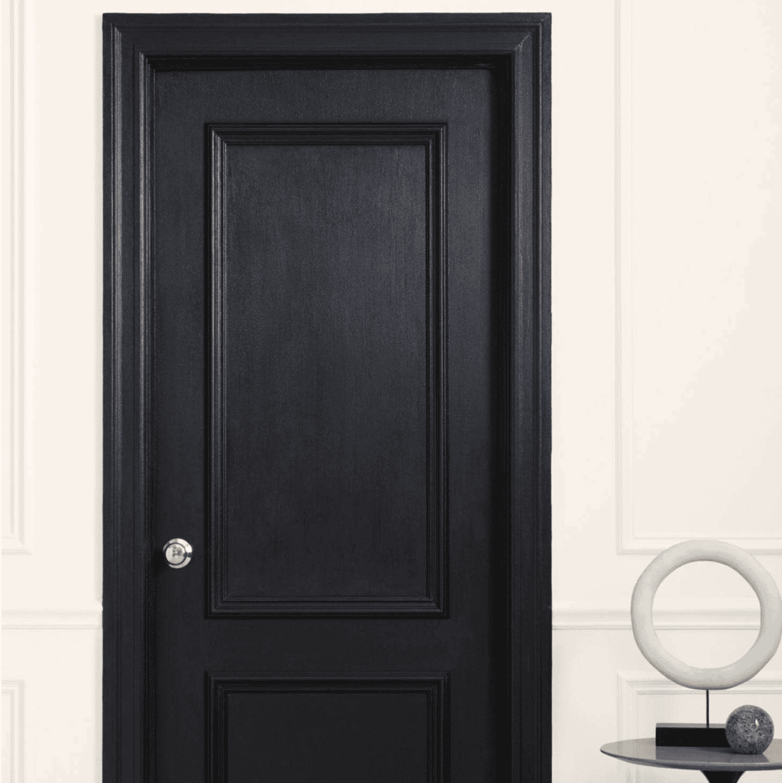 Black door in a white wall.