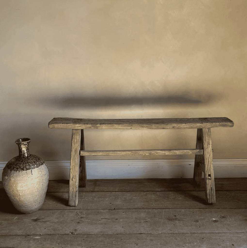 Wooden bench in a room with wooden floors.