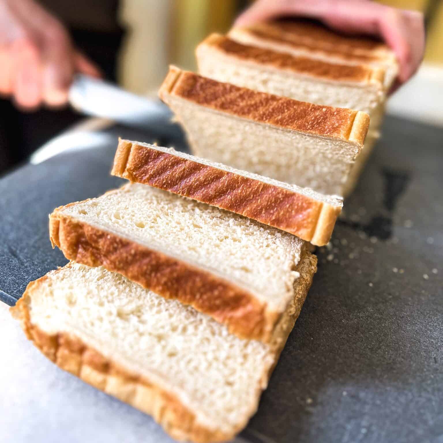 Person slicing Japanese milk bread.