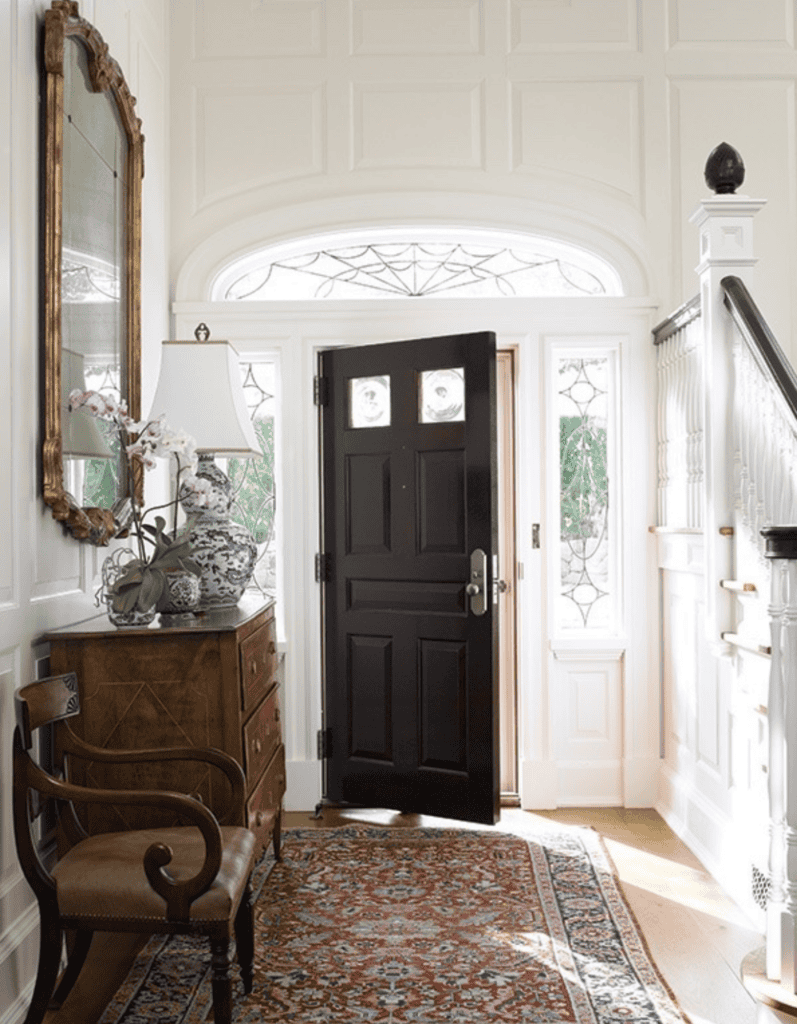 Open black door in a white house.