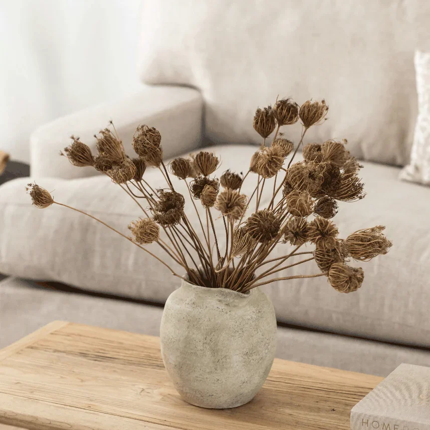 Dried flowers in a light vase.