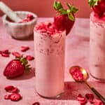 Strawberry acai drink in a tall glass.