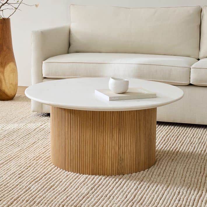 Round marble coffee table in a bright room.