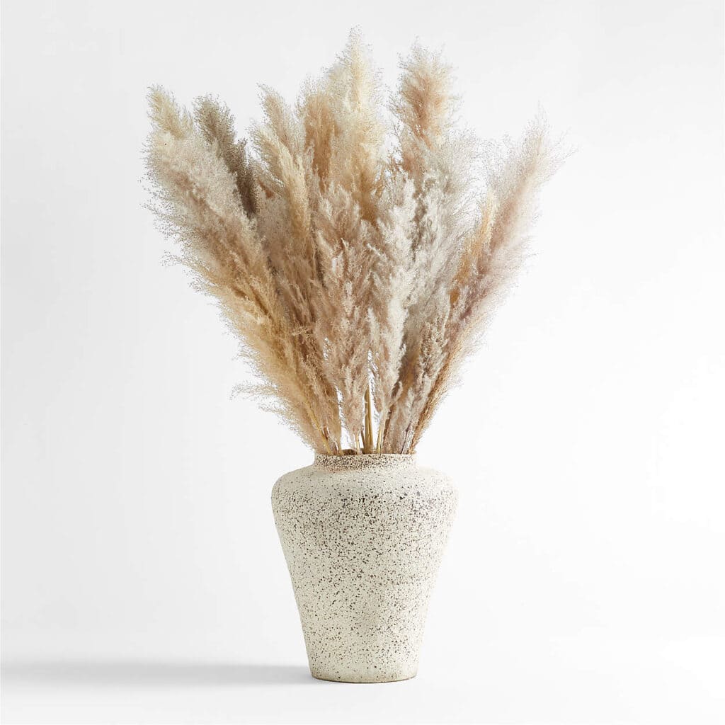 Neutral-colored dried botanicals in a light vase.