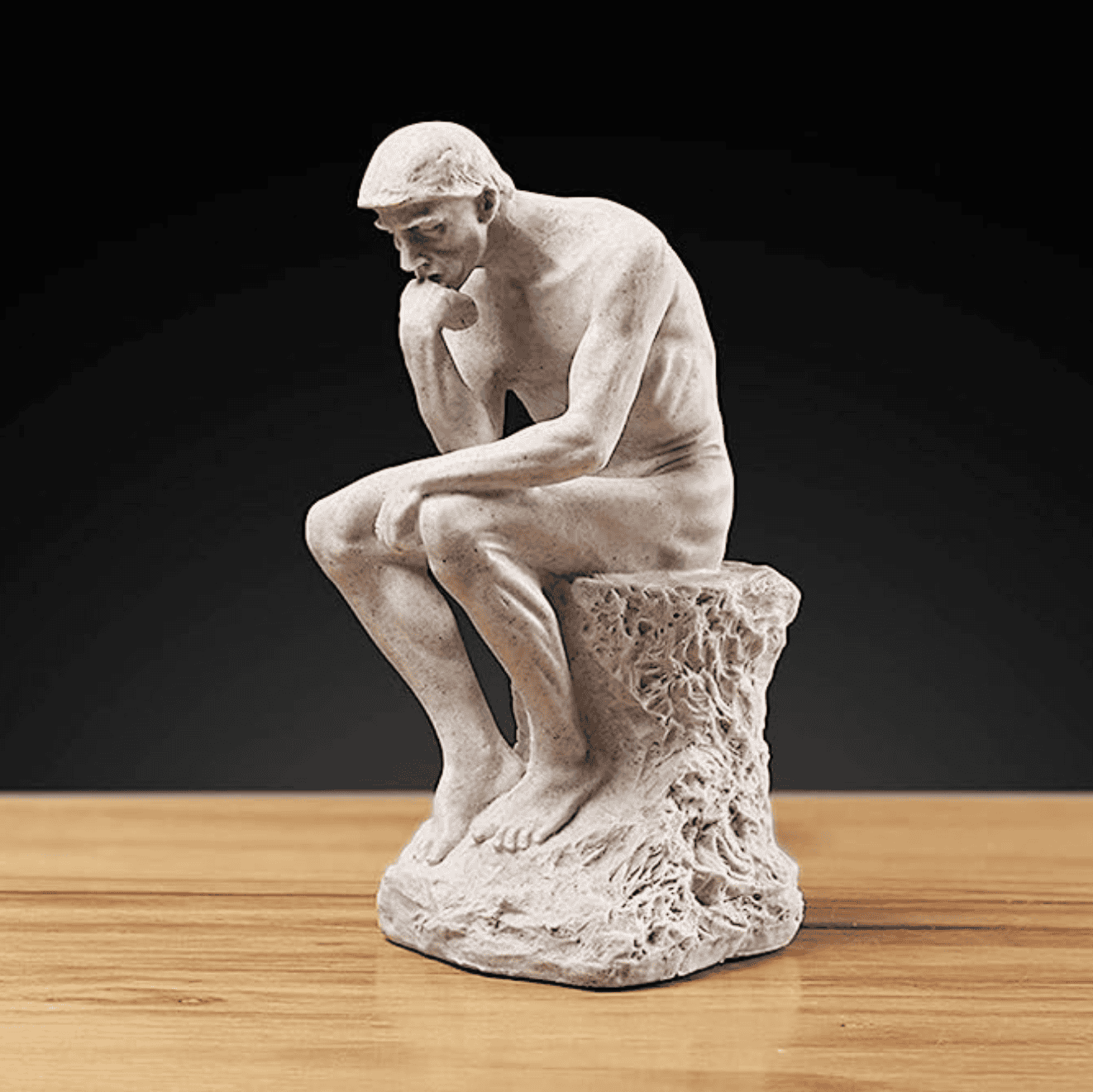 Creative thinker statue on a wooden table.