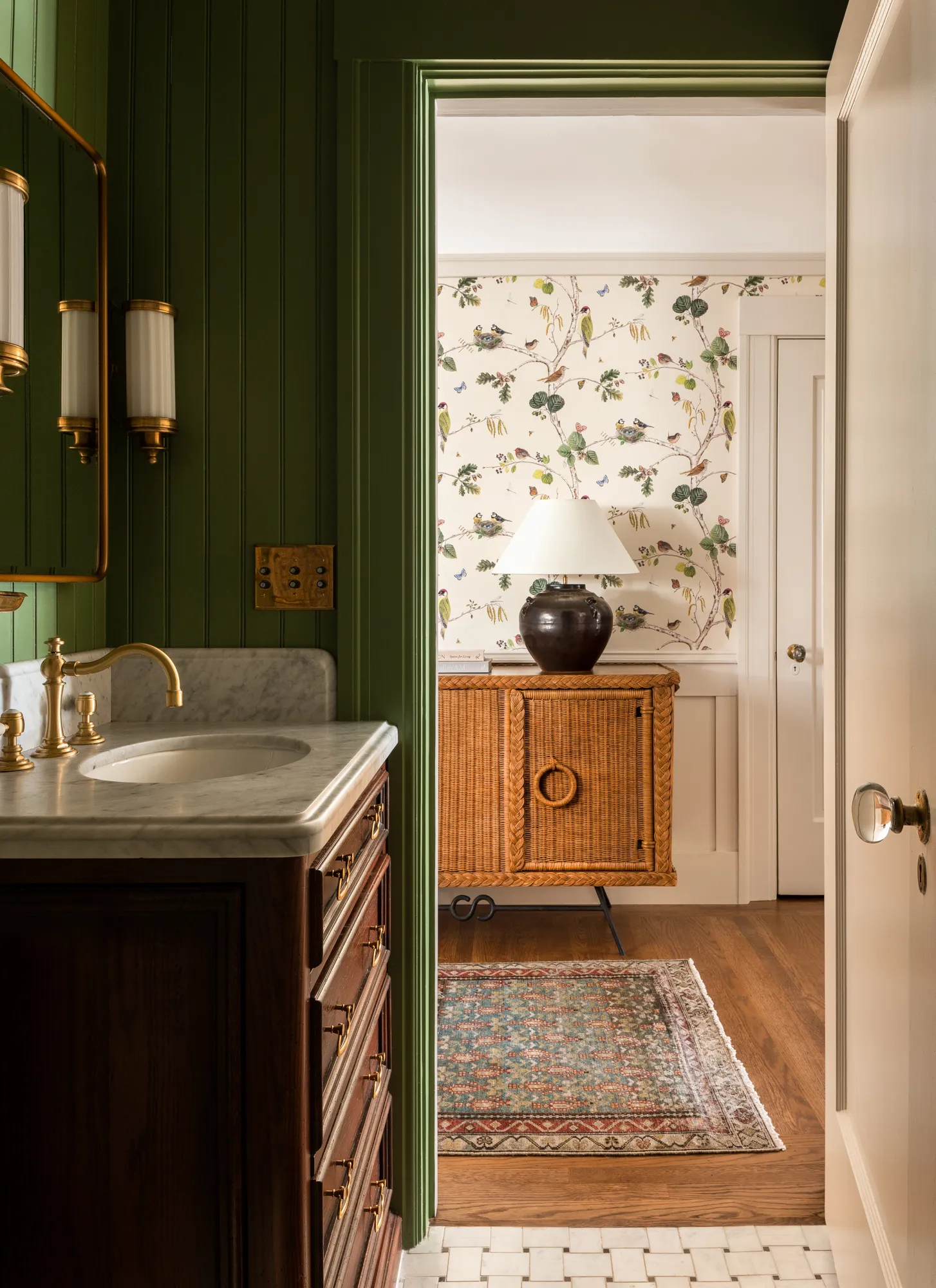 easy bathroom upgrades include green wainscoating, wallpaper, vintage rugs, and restore hardware with new sconces.